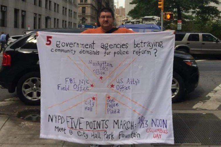 This protest banner announcing the NYPD Five Points March was unfurled outside the office of Manhattan District Attorney's Office on September 29. Source : File Photograph