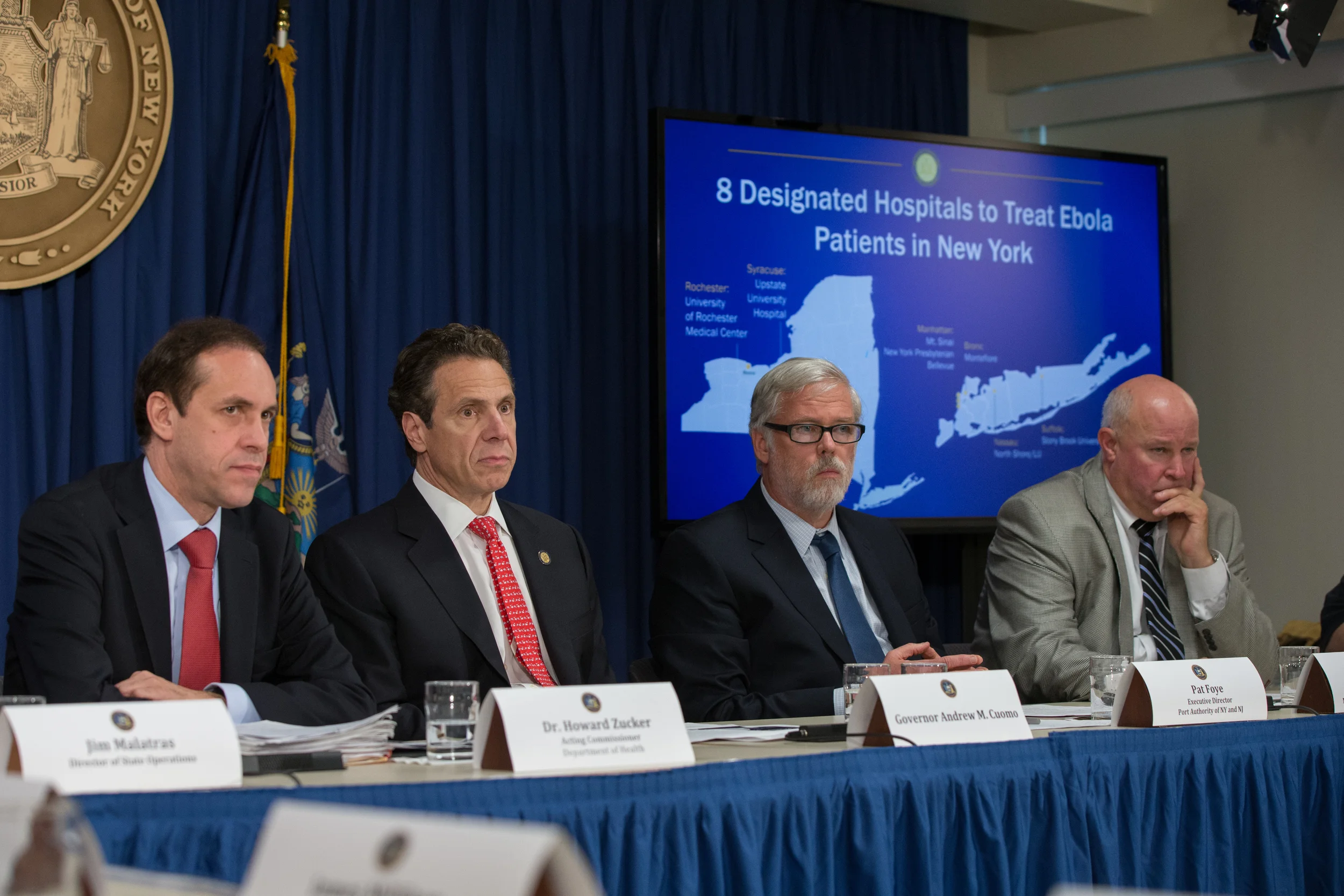 Dr. Howard Zucker , the state's acting commissioner of the Department of Health ; Gov. Andrew Cuomo (D-NY) ; Pat Foye, executive director of the Port Authority of New York and New Jersey ; and Tom Prendergast , chairman and chief executive officer of the Metropolitan Transportation Authority at the announcement last week of eight designated hospitals to receive and treat people with Ebola. Source : Official Photograph/Governor's Office