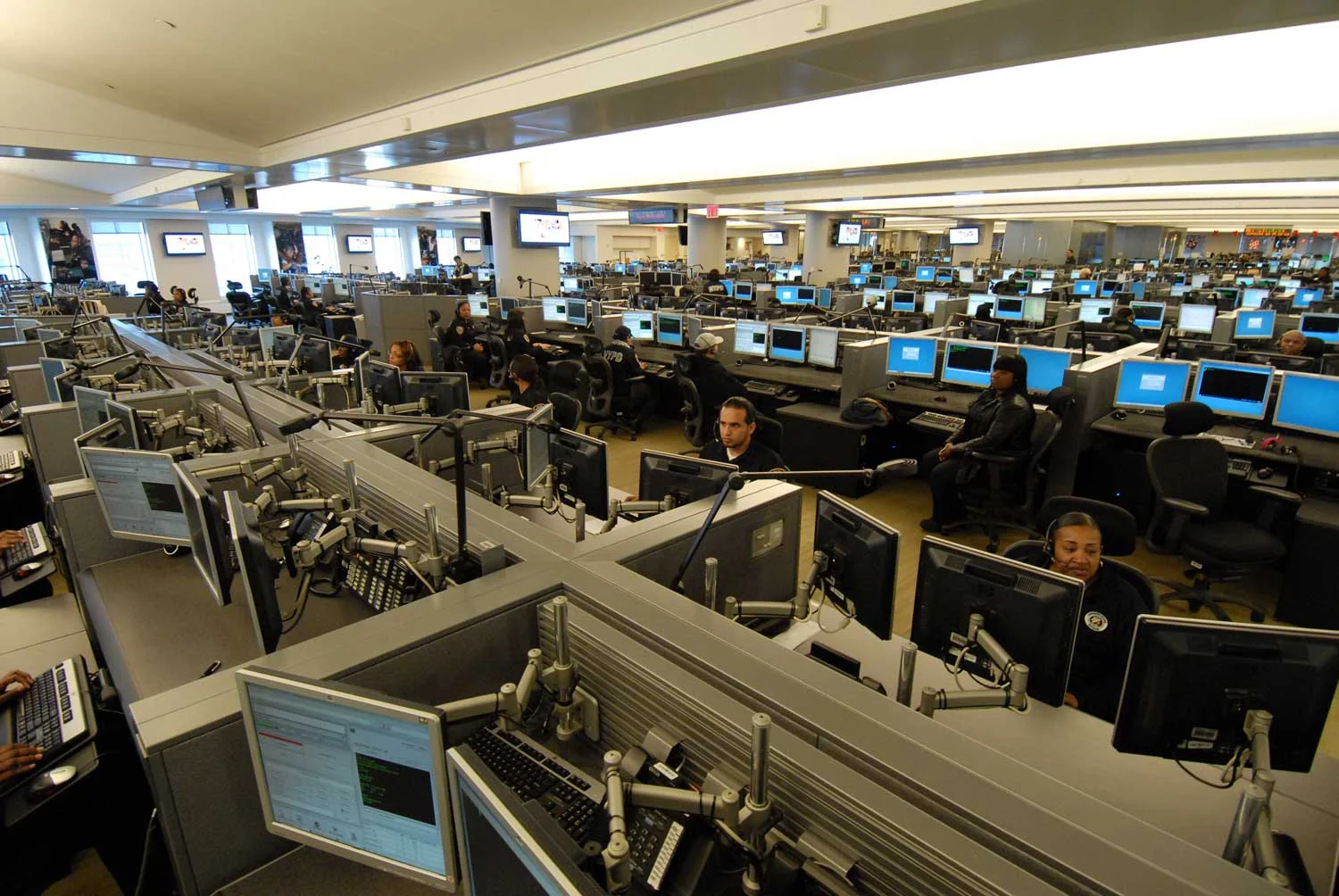 The emergency call center in Brooklyn, where operators are supposed to be aided by a sophisticated computer system upgrade that was supposed to streamline the dispatching of 911 emergency response services. The system upgrade has been hobbled by technology problems, is many years behind schedule, and is about $1 billion over budget. Source : Official Photograph/New York City