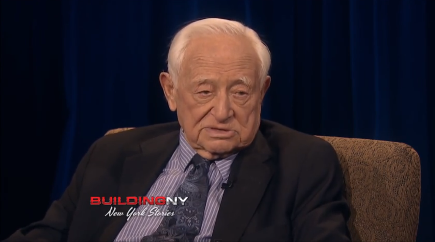 Former Judge Milton Mollen , seen here in a 2013 interview on CUNY TV 75 , served as the chair of a famous investigatory panel appointed by former Mayor David Dinkins in 1992 to investigate corruption at the New York Police Department . Judge Mollen spoke with Progress Queens in a wide-ranging interview about the raging debate calling for policing reforms. Source : CUNY TV 75/YouTube Screen Shot