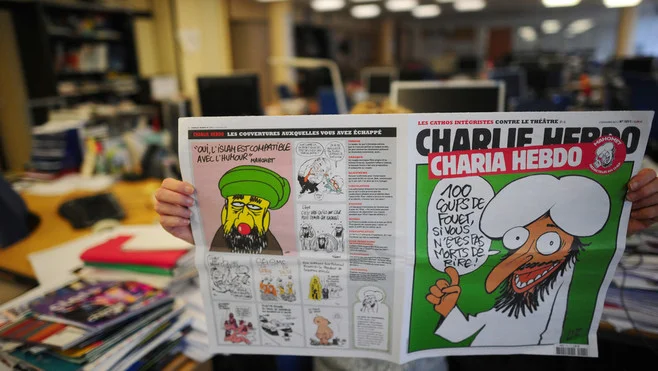 An uncredited photograph of the controversial November 3, 2011, issue of Charlie Hebdo , published by the French edition of The Huffington Post , shows the front page that The New York Daily News censored from their Web site. Source : The Huffington Post