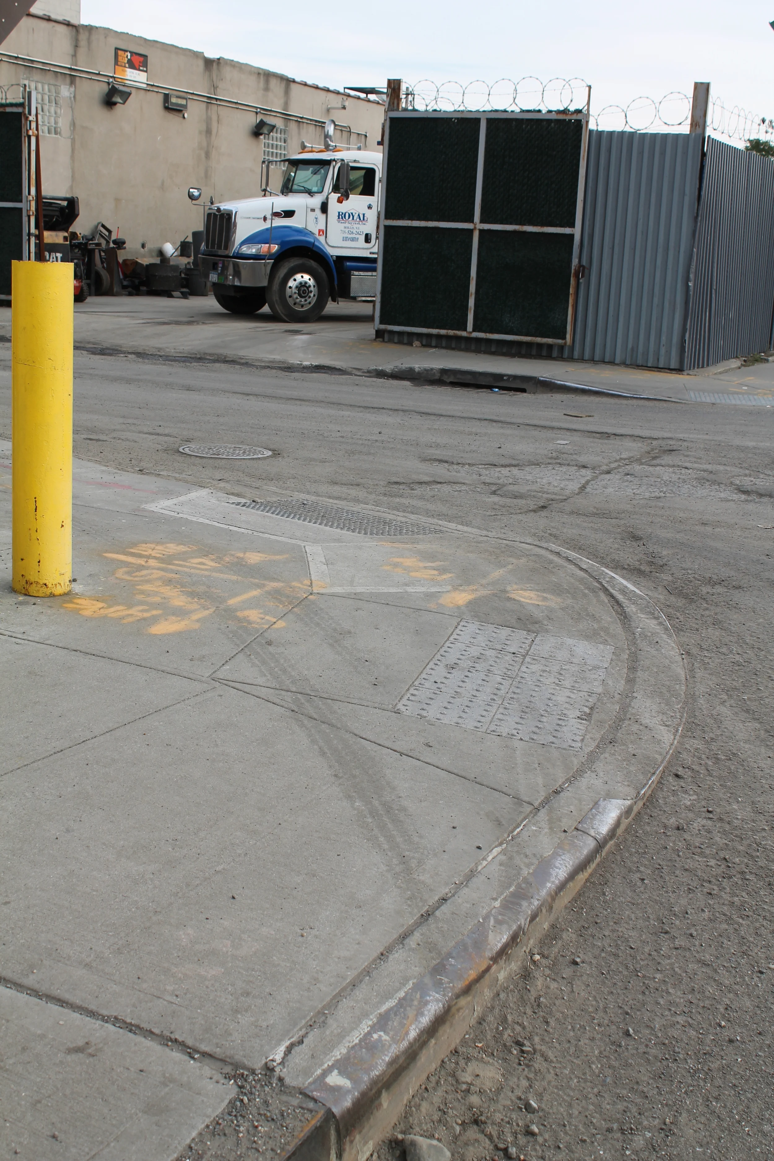 The drivers of some large and heavy commercial trucks are only to make wide right turns onto narrow residential streets in Jamaica, Queens, by jumping the wheels of their trucks onto sidewalks, leaving marks, such as those seen here on October 28, 2014, raising questions about the safety of pedestrians and other vehicular traffic in the residential neighborhoods of Jamaica. Source : Louis Flores