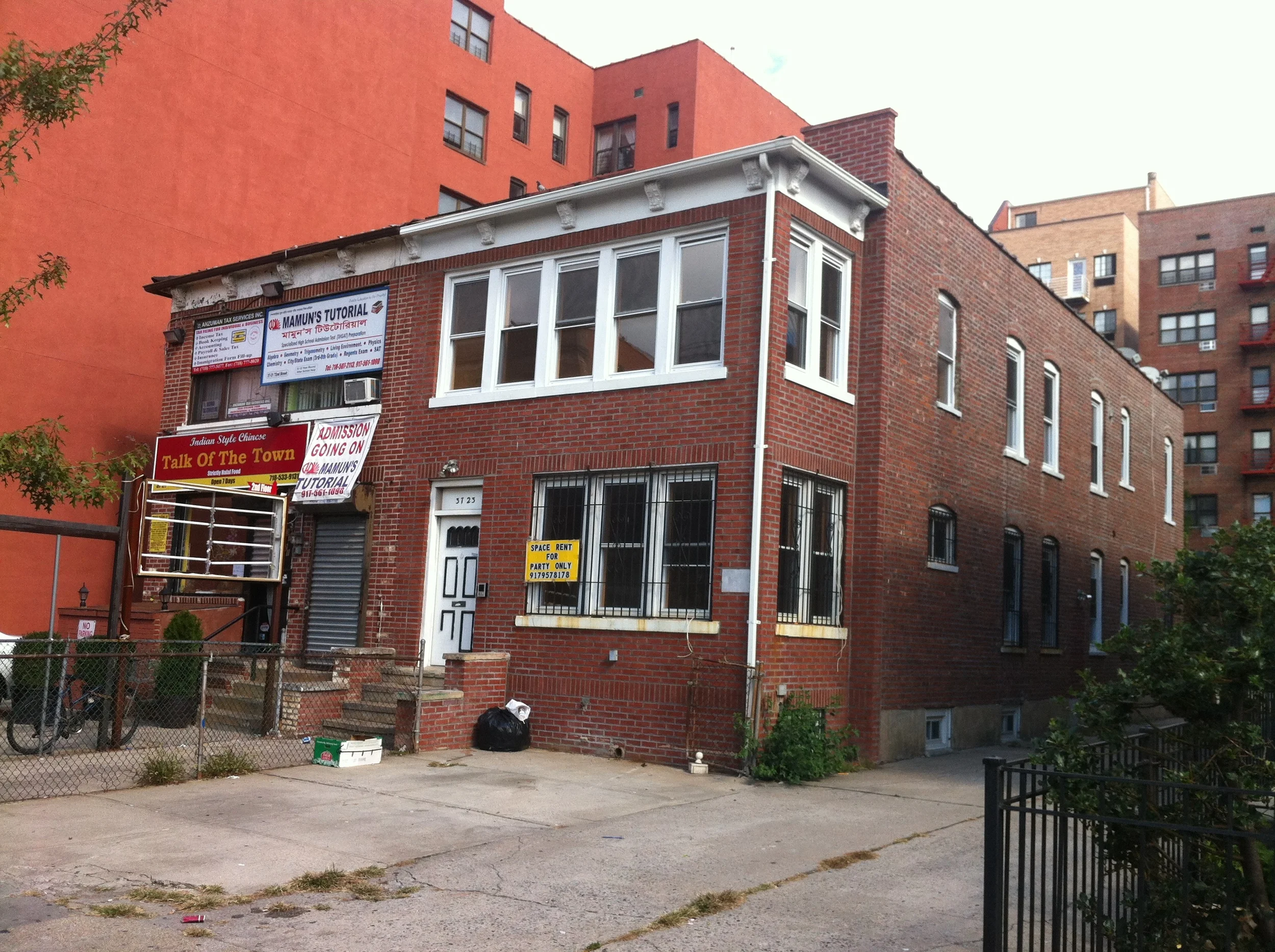 37-23 72nd Street, the site of a proposed 11-story hotel, is the attached house at right. Source : Louis Flores/Progress Queens