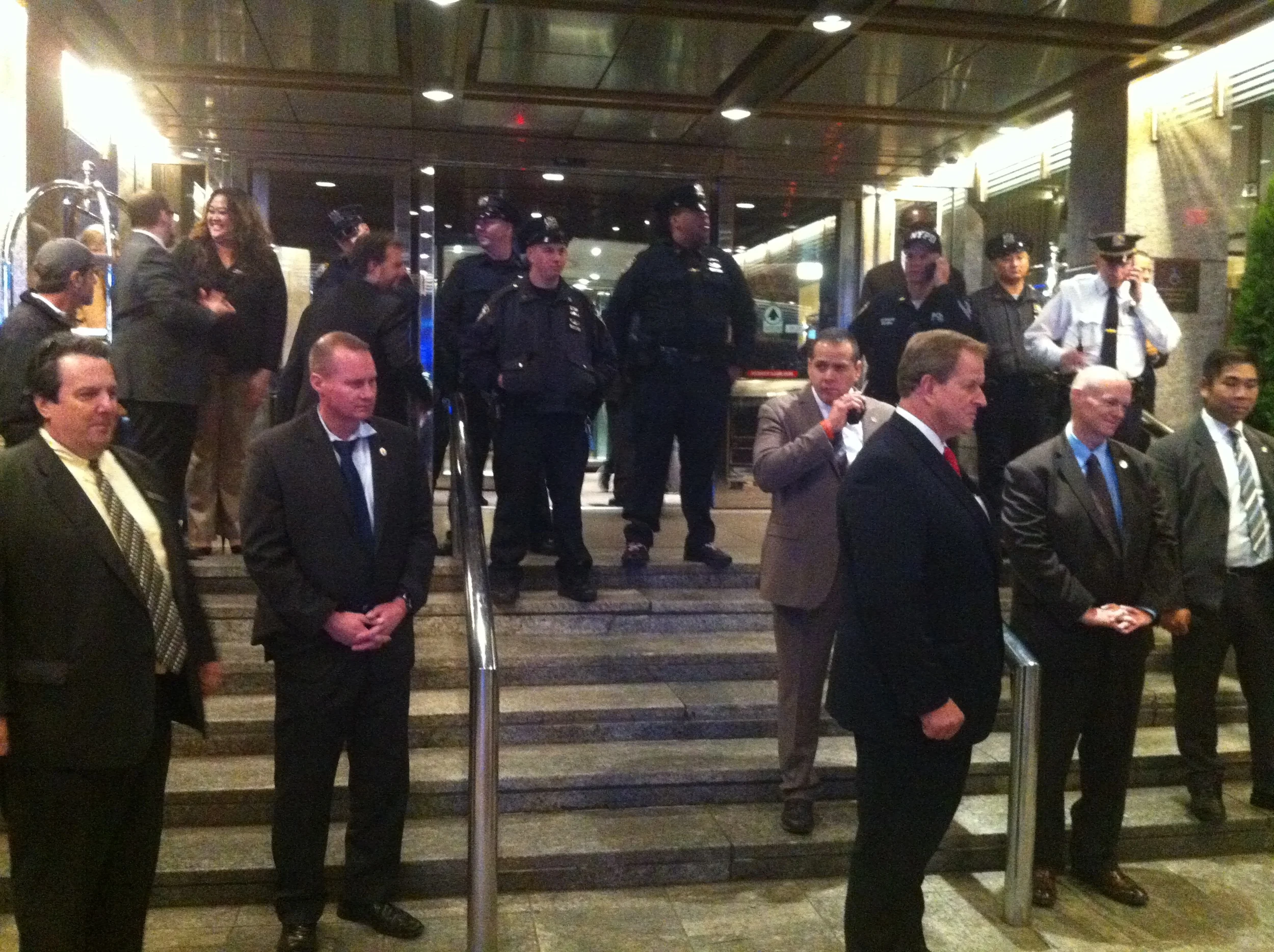 After activists rushed the main entrance to the Sheraton , the site of Mayor Bill de Blasio 's fundraiser, NYPD officers blocked the entrance, placing he main entrance on temporary lockdown . Source : Louis Flores/Progress Queens