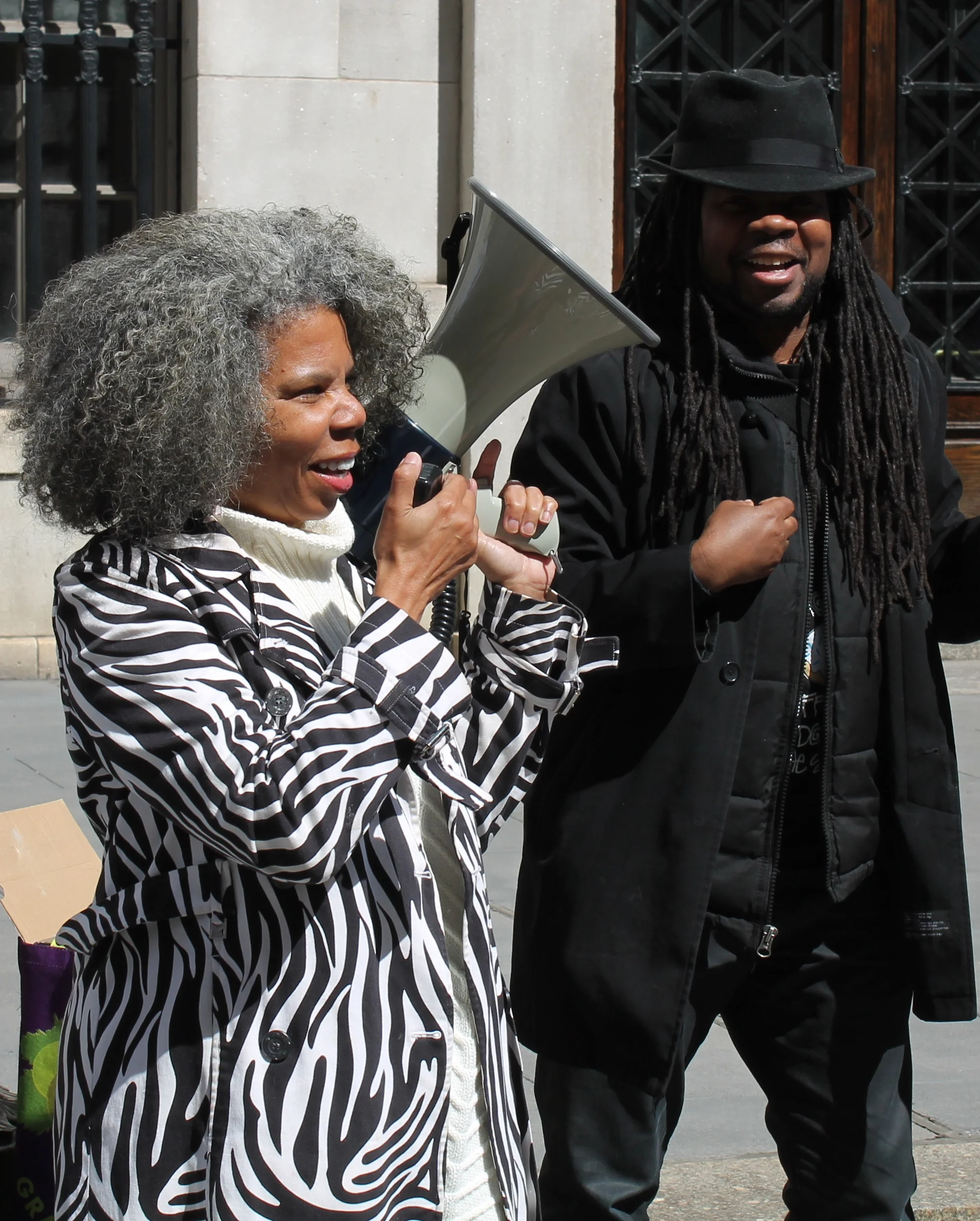 Alicia Boyd, left, with Imani Henry, at the press conference. Activists had applied for and received a permit for the use of amplified sound. Permits are provided by the New York Police Department. As a consequence of the permit, there were at least eight uniformed police officers observing the press conference and speak-out. Source : Louis Flores