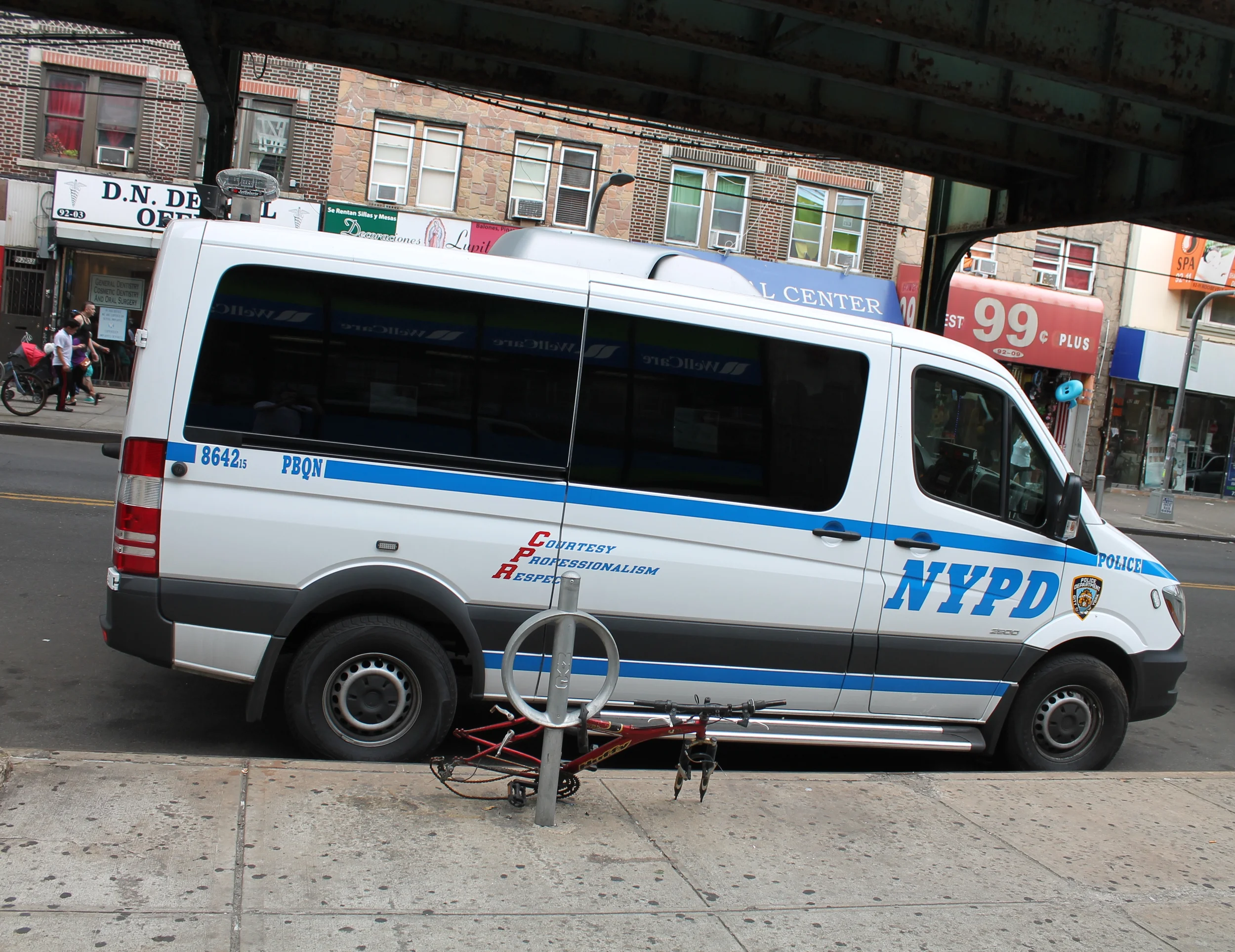 One of three NYPD vehicles parked outside the offices of Make the Road New York on Monday afternoon. Source : Louis Flores/Progress Queens