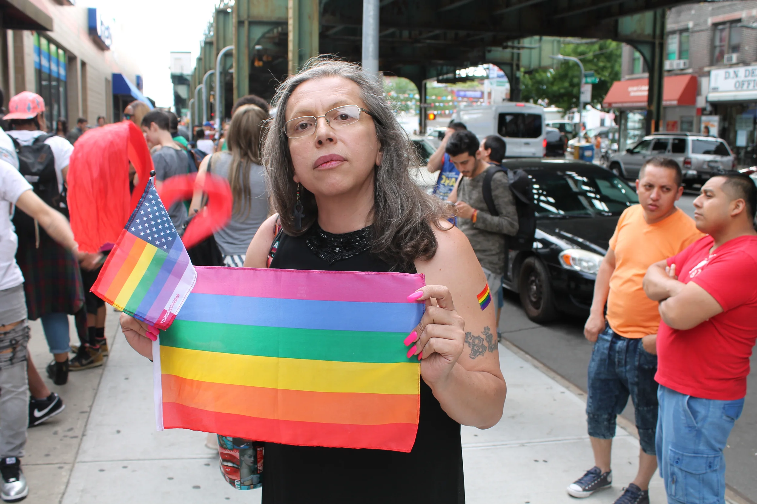 The activist Brooke Cerda Guzmán standing amongst dozens of activists and supporters outside the offices of Make the Road New York prior to the start of the Trans Latina March . Source : Louis Flores/Progress Queens