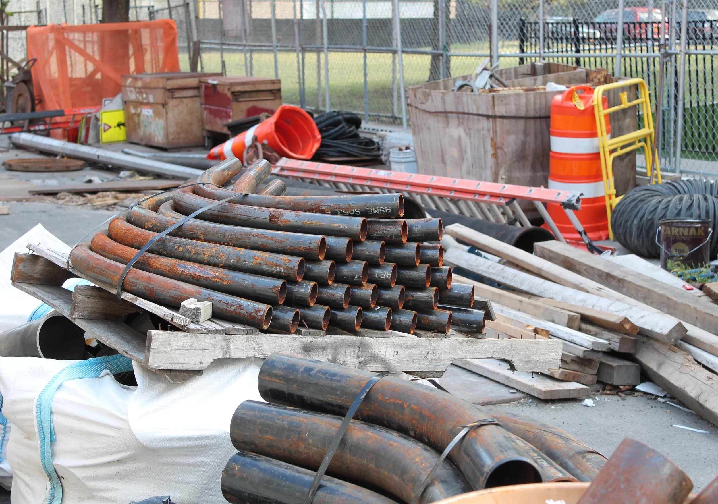 Inside an MTA staging area, construction materials were scattered inside a fenced-in zone alongside East 101st Street near the southeast corner of Second Avenue. Source : Louis Flores/Progress Queens