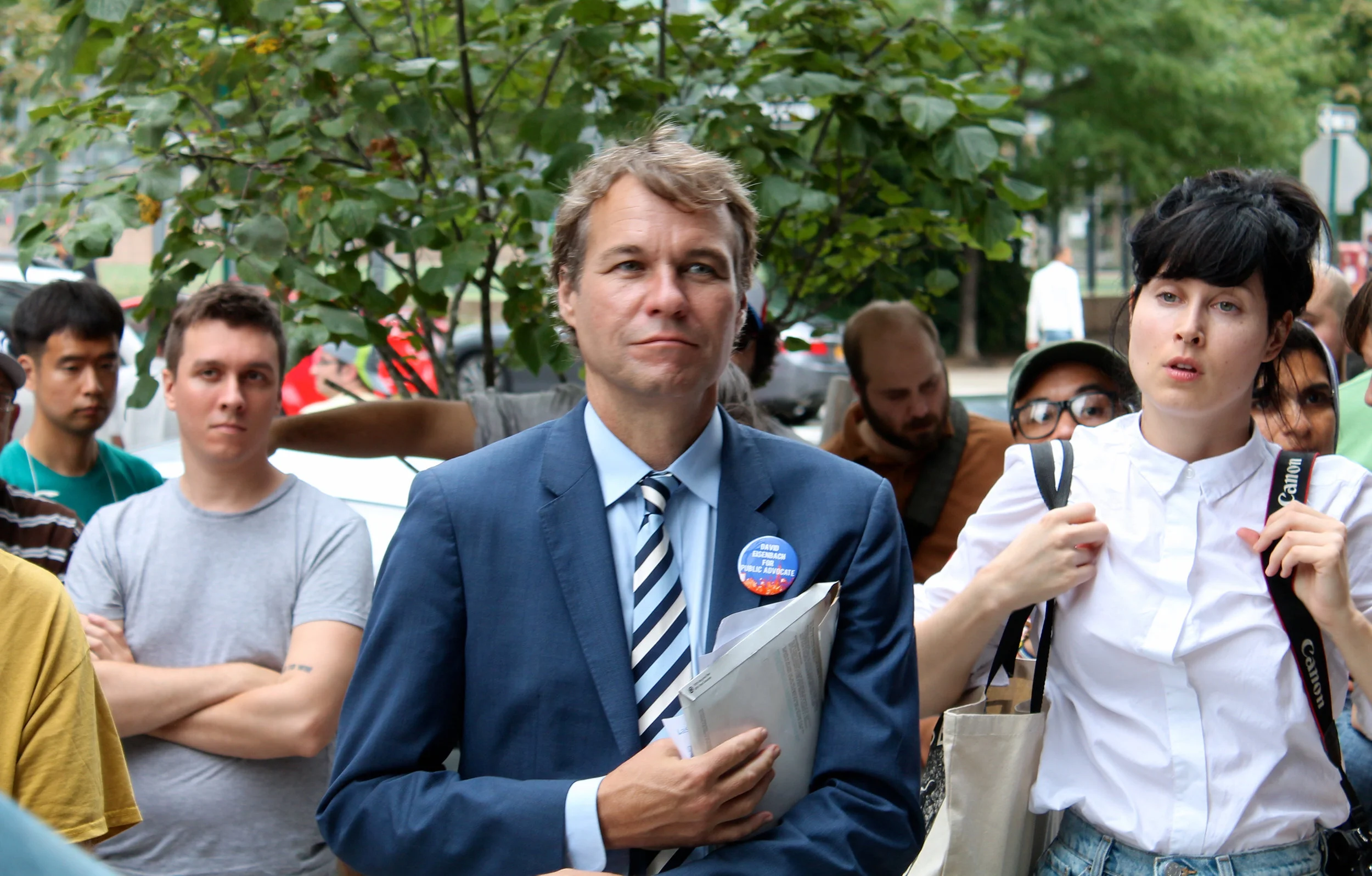 David Eisenbach , who teaches history at Columbia University, is a candidate for Public Advocate in the Democratic Party primary election in September. He joined the Queens Gentrification Tour to promote his campaign promise to help small businesses win rent protections. Source : Louis Flores/Progress Queens