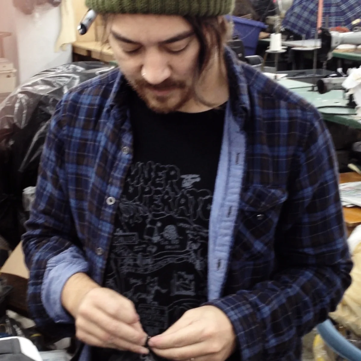 Steven knotting zipper pulls in the factory, NYC 2011