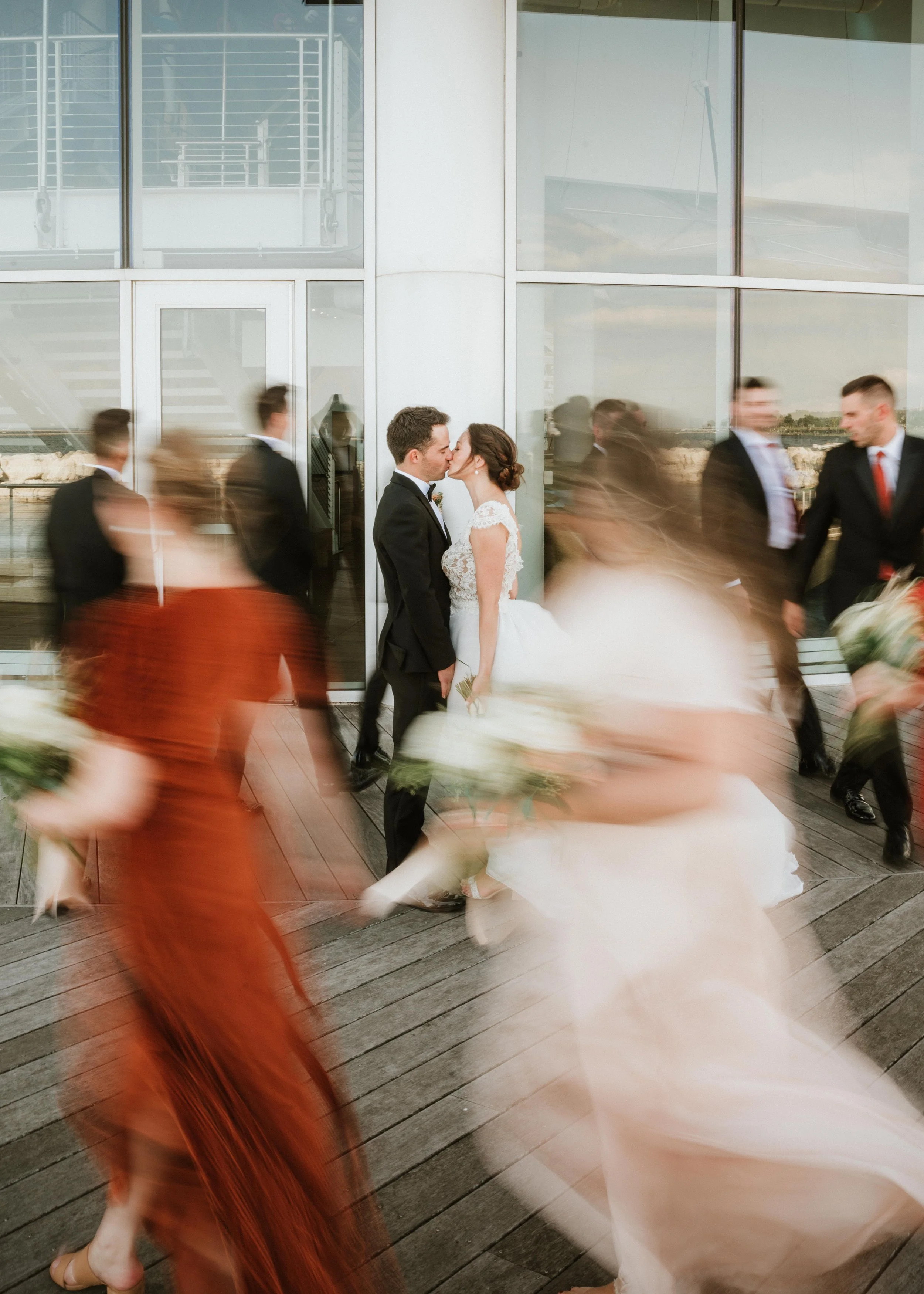 Bride & Groom taking pictures with the Wedding party at Discover World in MKE