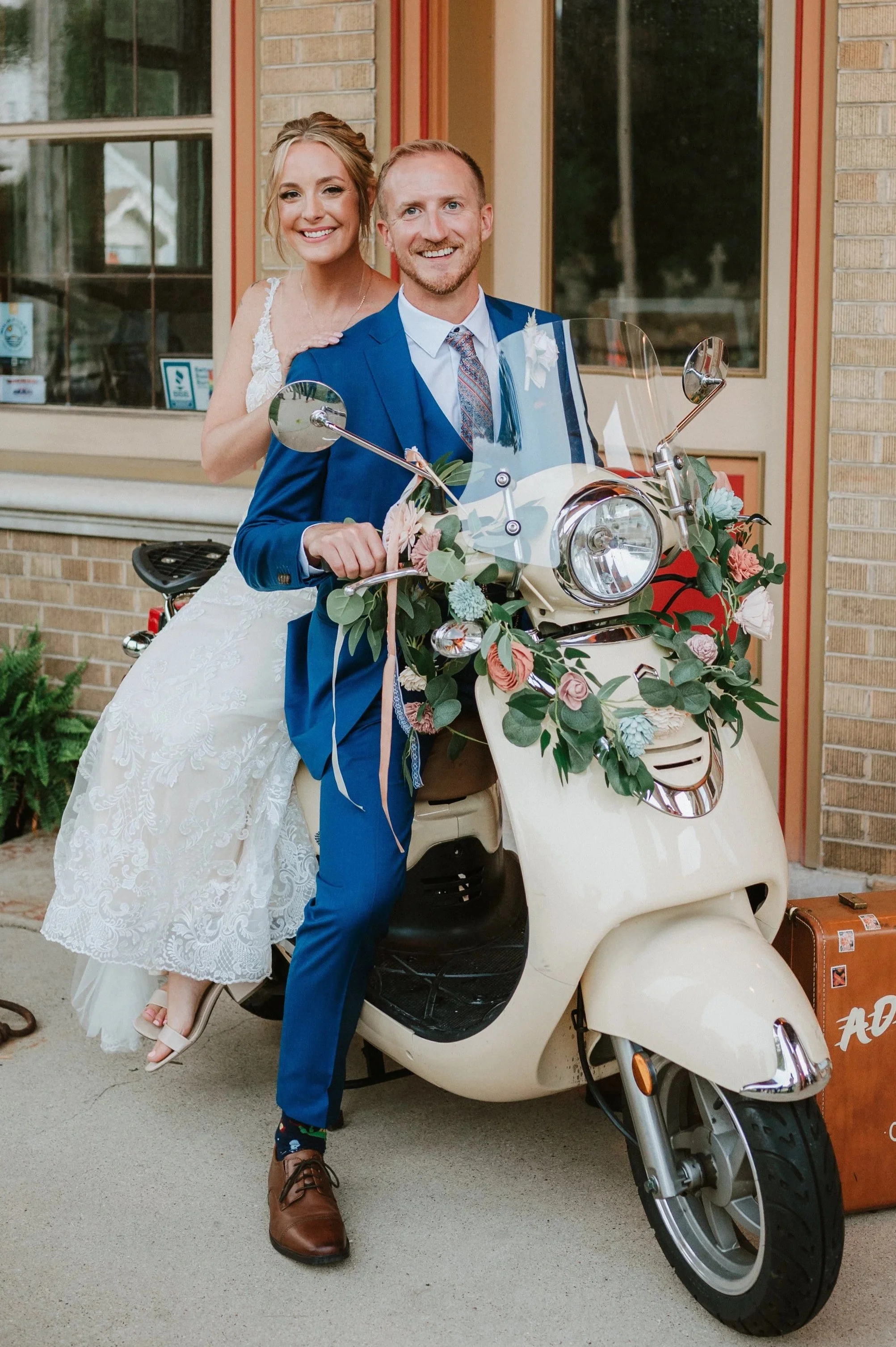 travel themed wedding couples rides their scooter at the Story Hill Hirehouse in Milwaukee