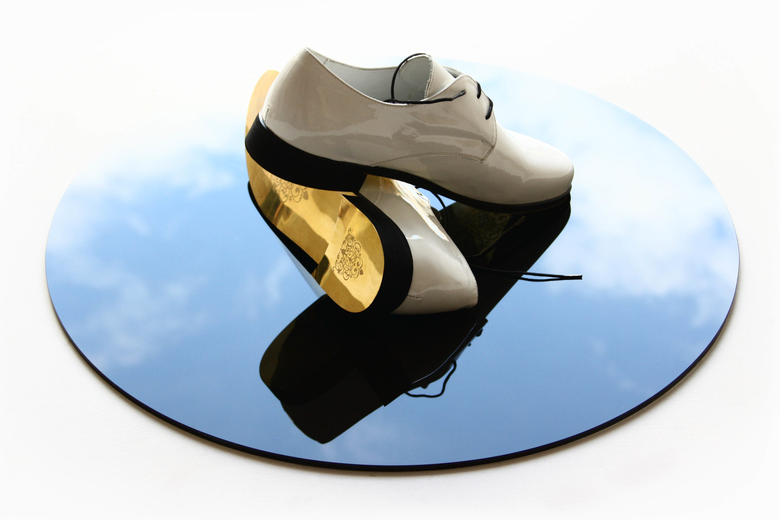 GOLDEN SHOES FOR GOLDEN ROUTES (2010) engraved bronze, leather, lacquer, black glass, 20 x 55 x 55 cm