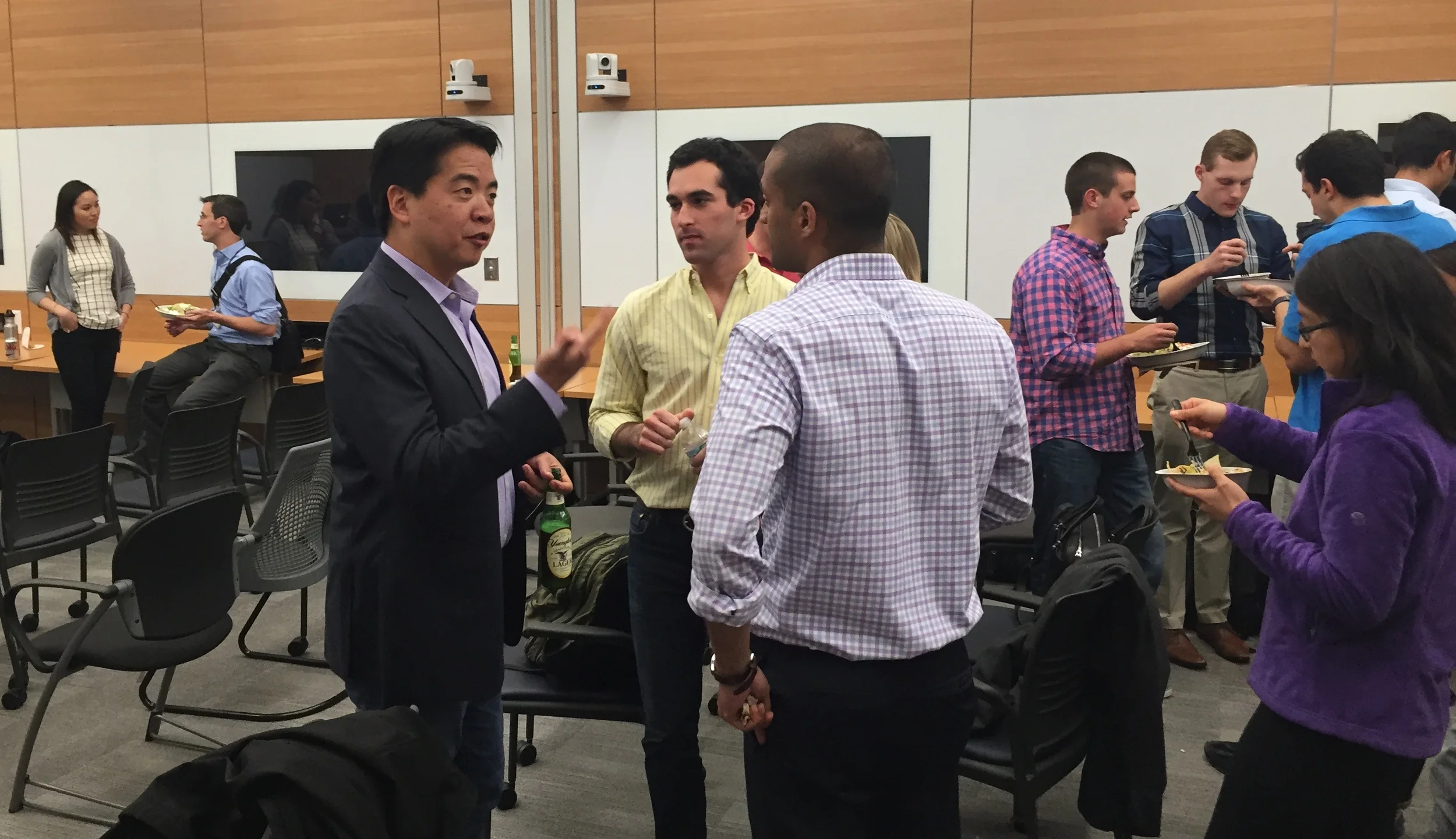 Lorence Kim, M’99, WG’99, speaks to Alex Rosen, M’16, WG’16, and Vinayak Nikam, M’17, WG’17. 