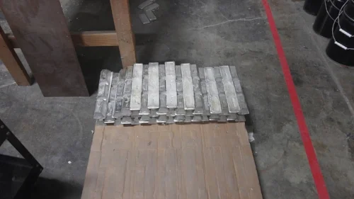 Stacks of pewter ingots waiting to become fantasy miniatures. Each one weighs about 15 pounds and can craft about 100 individual figures.