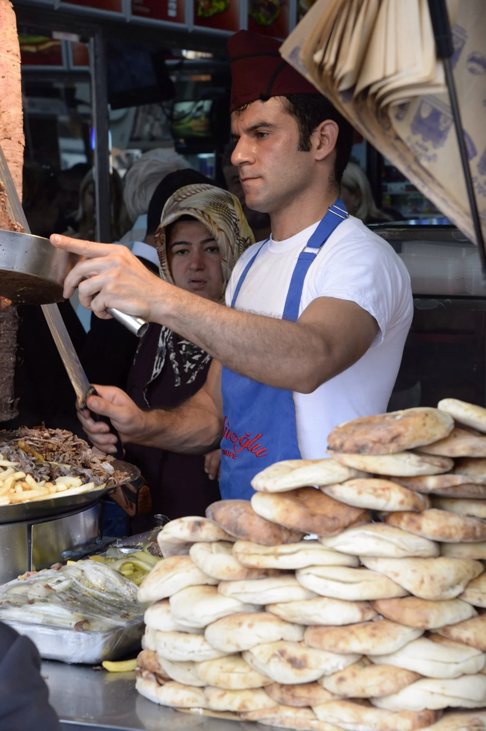 A cook prepares kebap at a stall