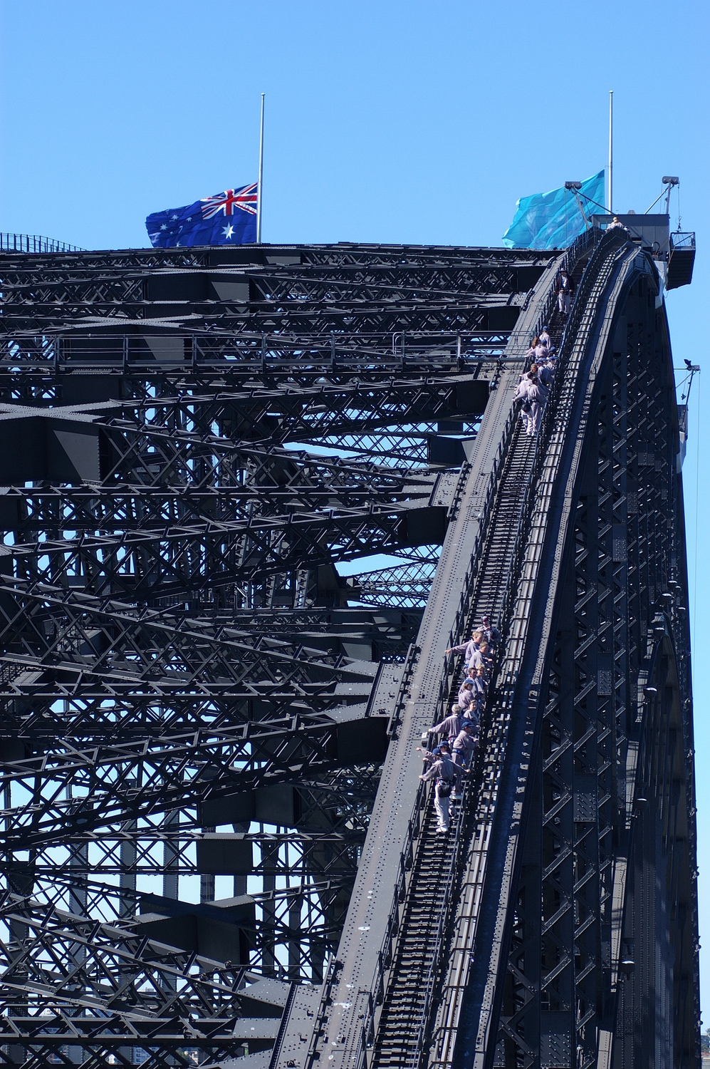Bridge Climbers working their way up the bridge- notice the flags still flying at half mast after the Bali bombings.