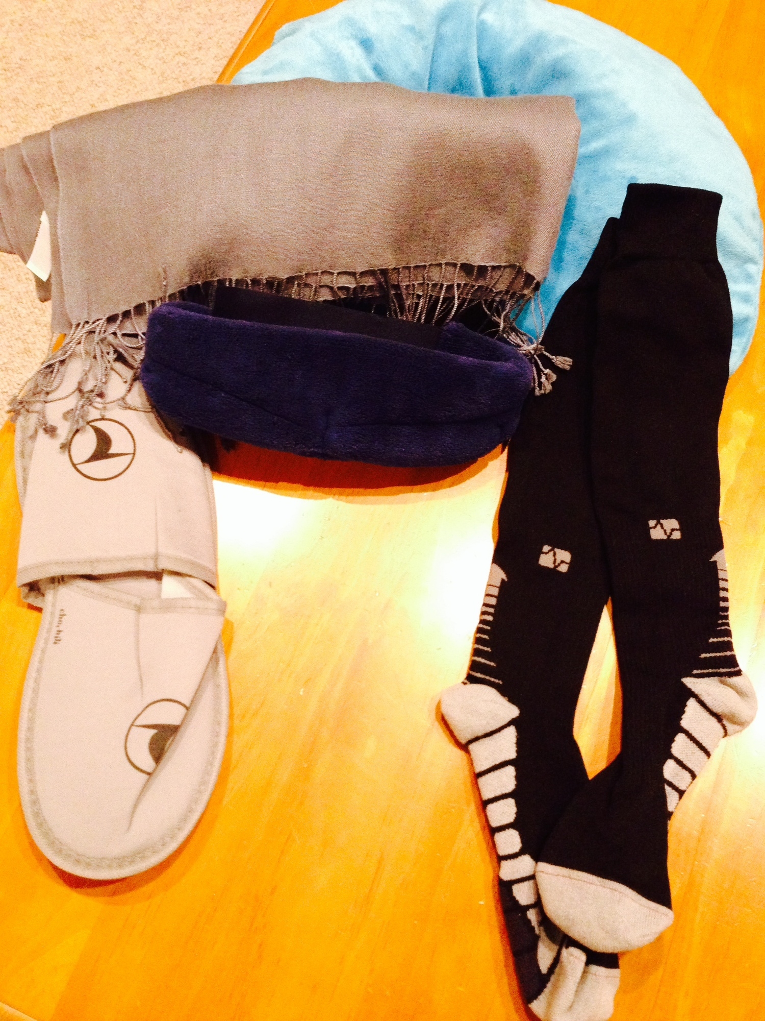 For long flights, I wear compression socks, pack slippers, pillow, blanket, and eye shades