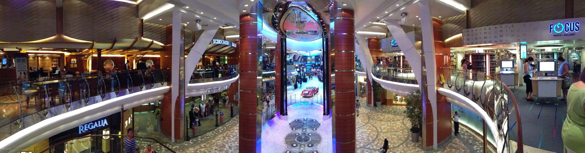 A panorama of the Royal Promenade from the staircase. Guest services on the left and the photo shop on the right.
