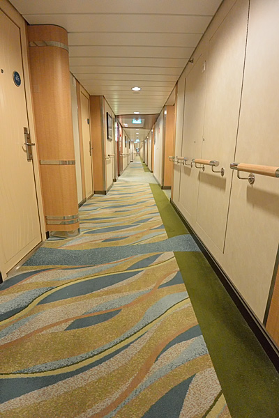 Cabin hallways are wide and bright, doors are recessed along the hallway, minimizing luggage clutter on departure day, and cleaning carts.