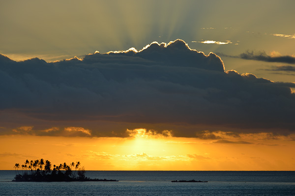 A motu at sunset in the South Pacific enroute to Bora Bora