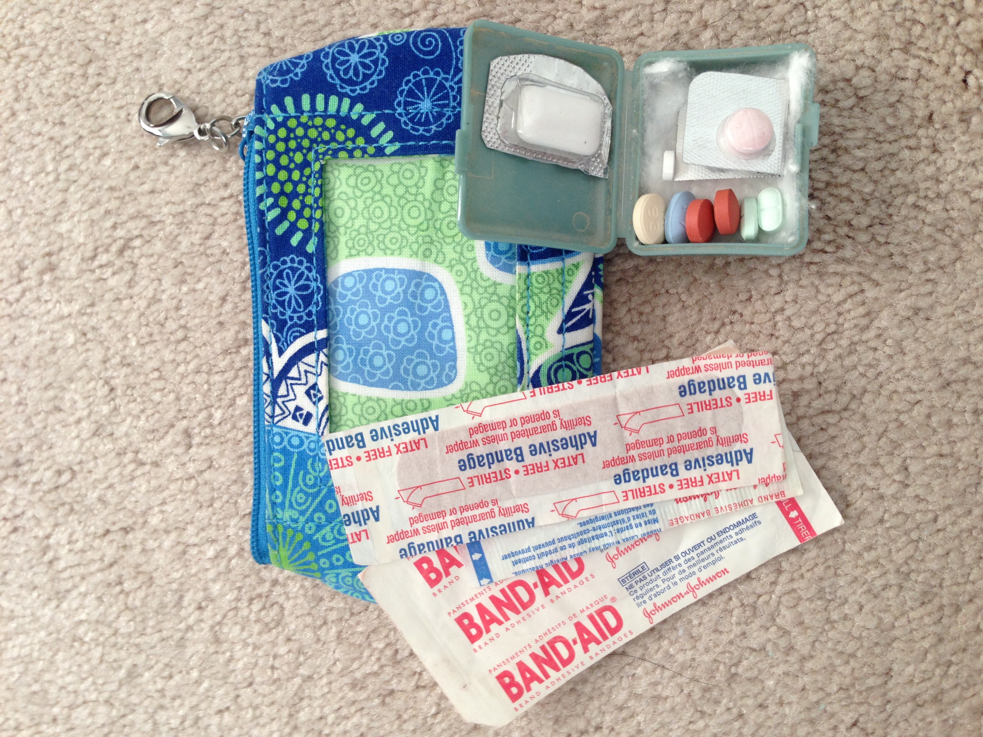 My go kit is tiny, it fits inside a small travel wallet along with a few bandaids. The clip wallet can attach to a belt loop for places where you don't want to carry a whole day pack. If you can't remember which pills are which, just put a photo in your phone with the names under each!