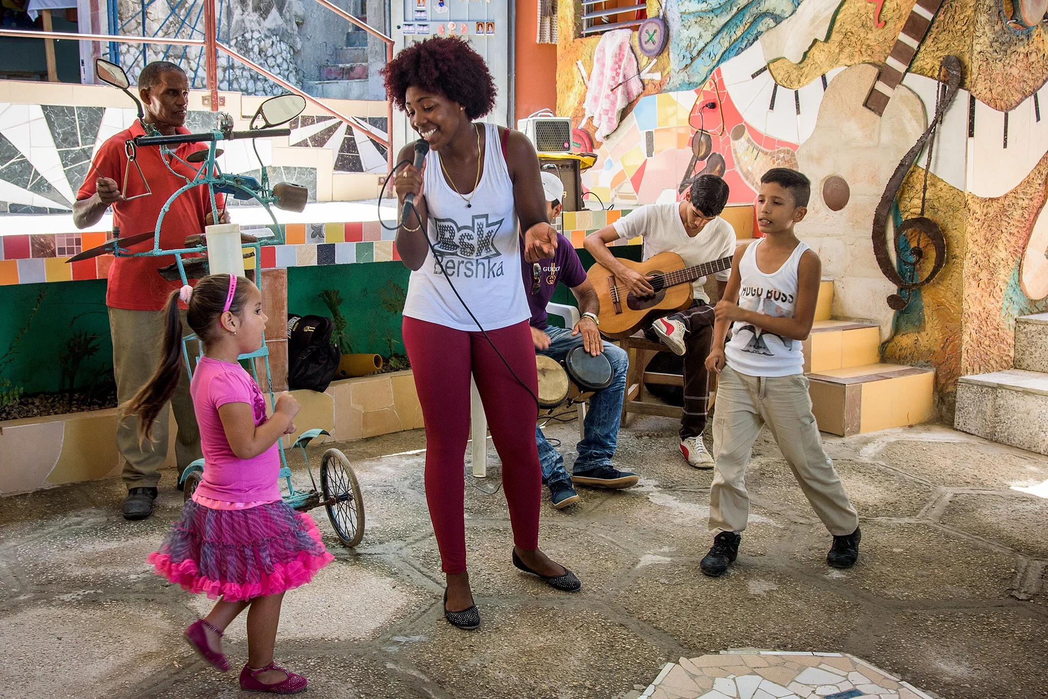 Community members dance at Muraleando, where locals have created art and music projects to enliven and enrich their cultural community. 