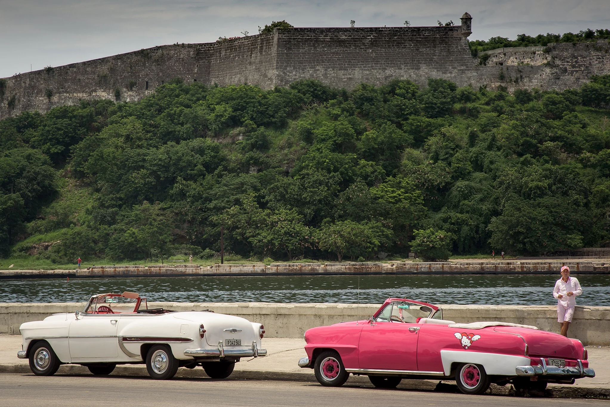 Some old cars along the Malecon in front of the Old Fortress. 
