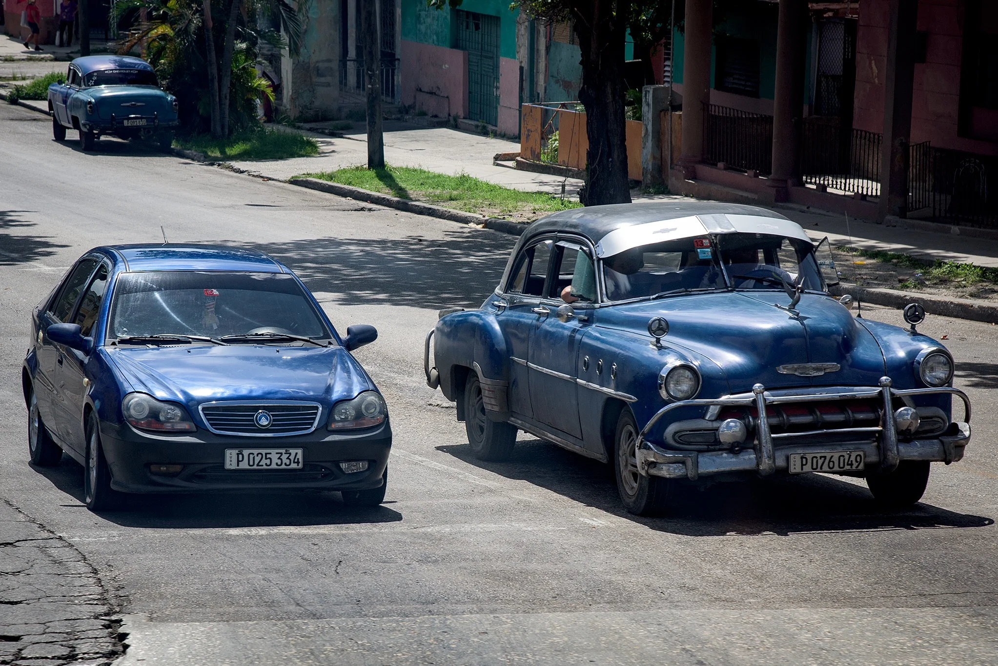 A rare "new" car in Cuba alongside a private "old" car. 