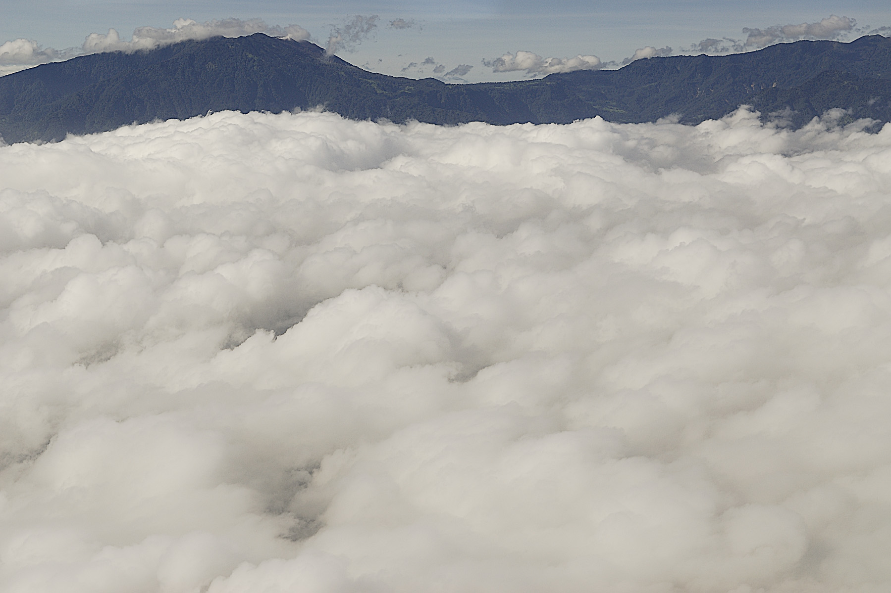 Above the clouds, but not above the mountains and volcanoes.
