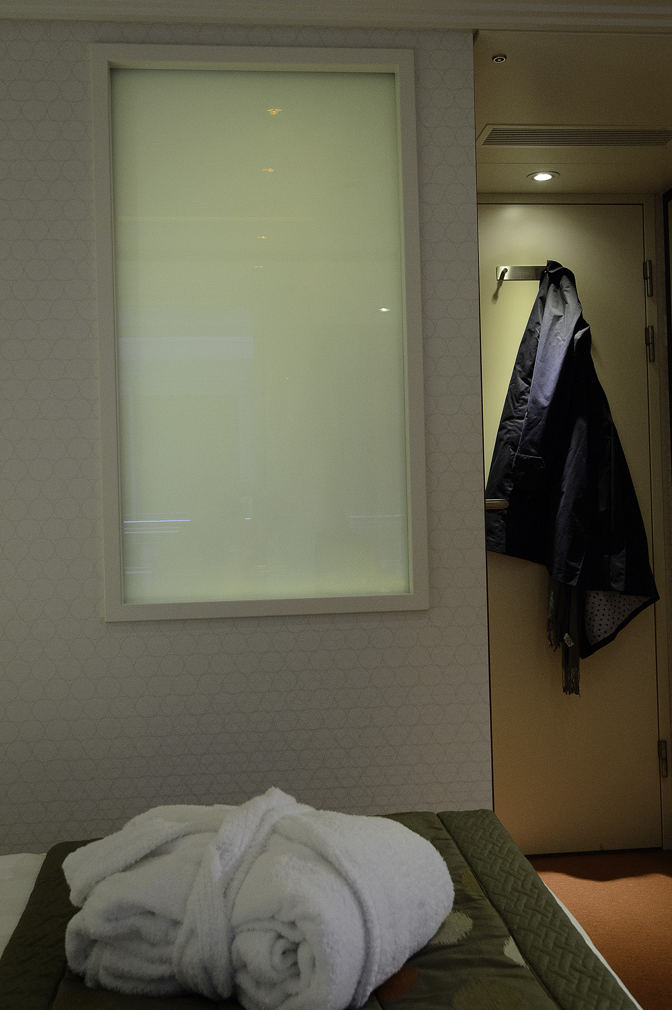 Window into bathroom with switch that "clears" the window, allowing natural light and views in the bathroom.