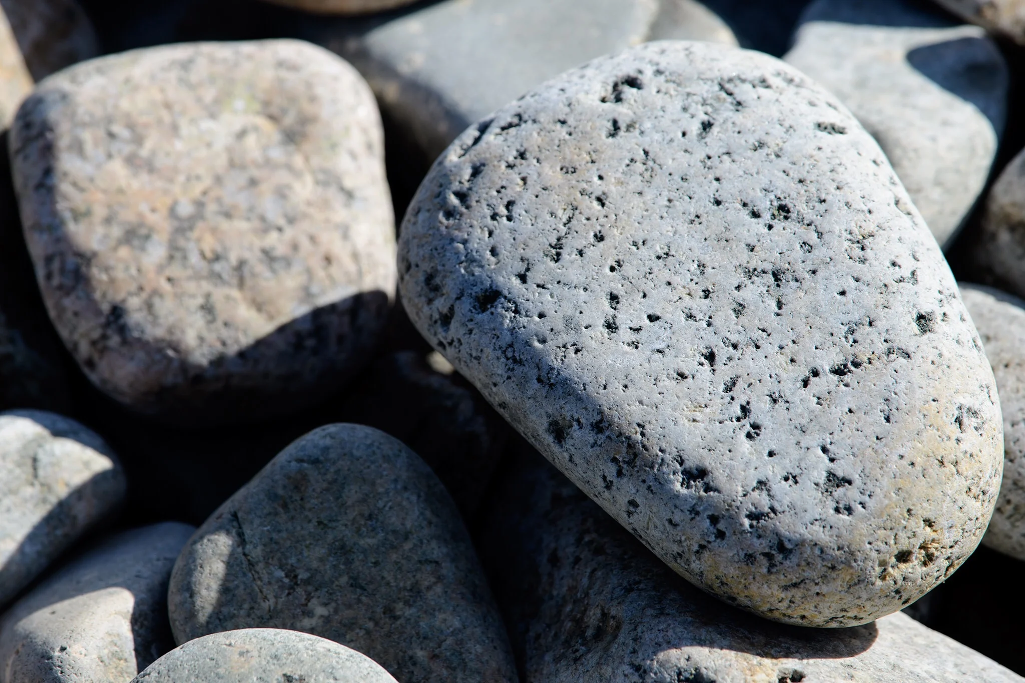 A huge pile of smooth stones are fascinating to examine in detail.