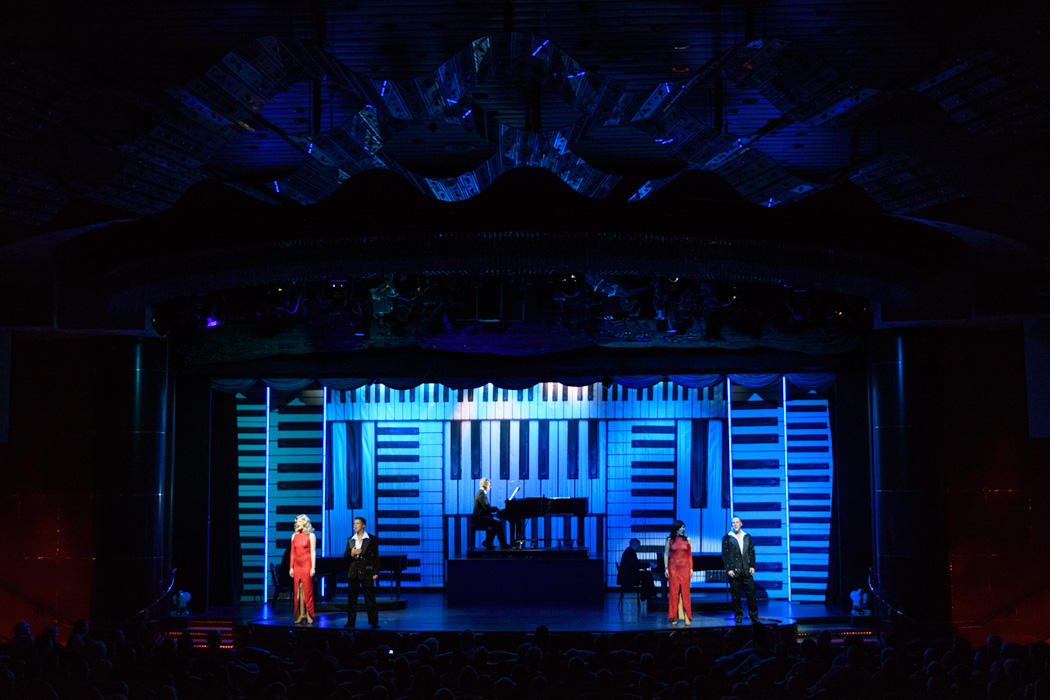 The production show featured a piano player and recorded music with live singers and dancers.