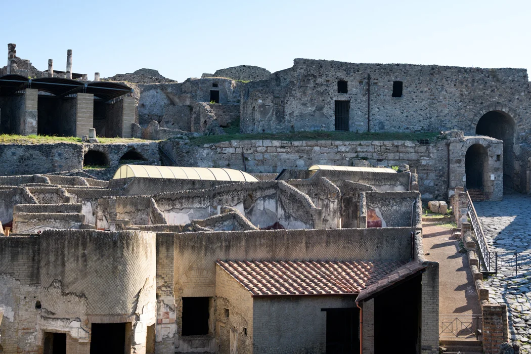 The outer walls were developed with buildings because at the time of the eruption, 79AD, things were peaceful enough for people to live and work outside the city walls. 