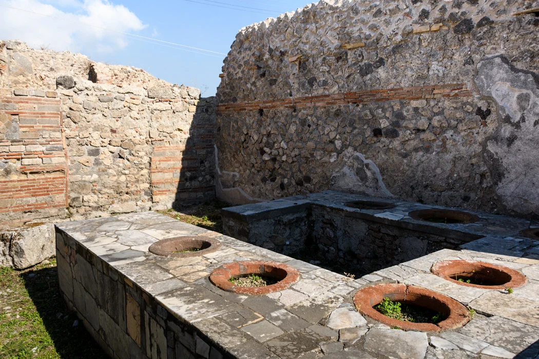 A Roman take out food restaurant; food was cooked in the ovens and served from the pots in the counter. People would come in, fill their dishes and leave the shop with their food. 