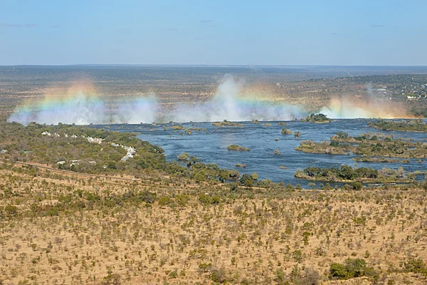 The Victoria Falls from helicoptor, known as "smoke that thunders" or Mosi oa Tunya, water vapor rises from the cataracts and the sun creates rainbows. Click on any photo below to expand.