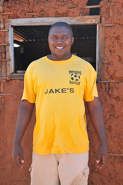 Junior, in front of his store, wearing a tee shirt from our home town!