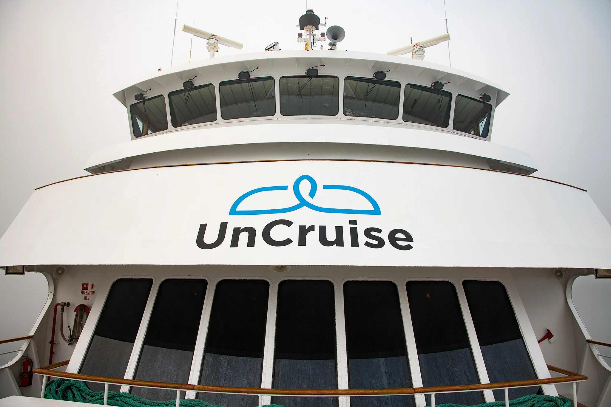A view of the panoramic lounge windows, promenade deck and bridge above.