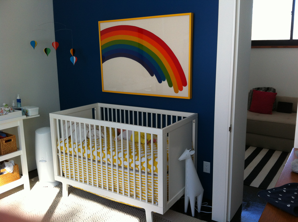 Happy rainbow print on fabric framed in yellow.