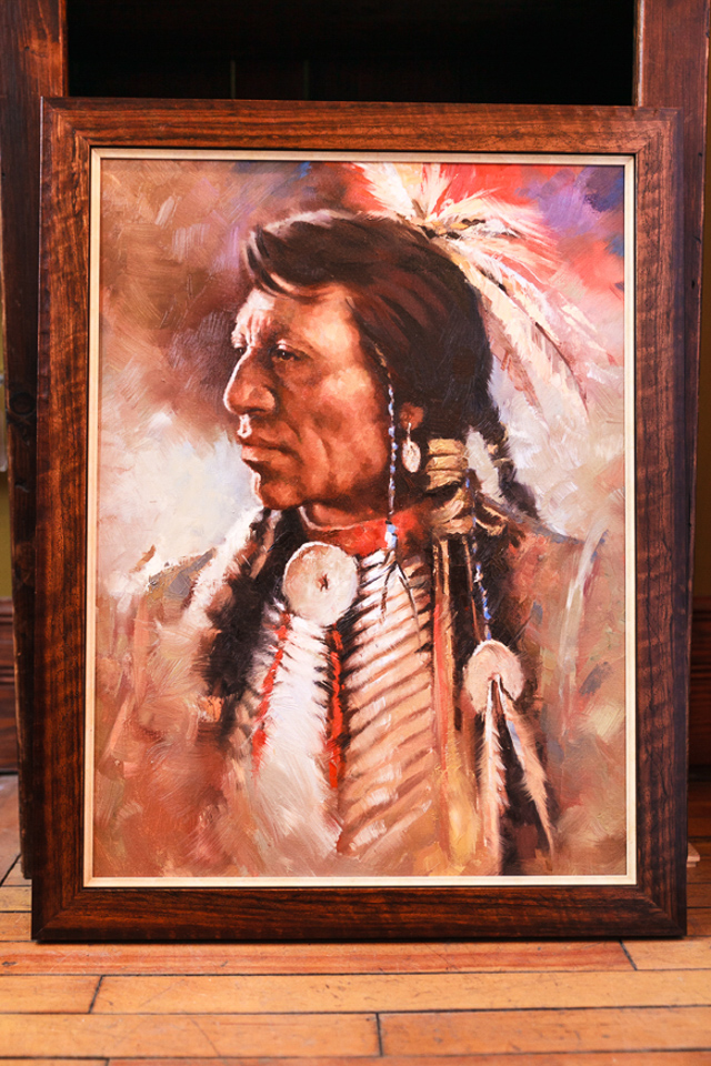 Native American warrior framed in tooled wooden frame with cream fillet.