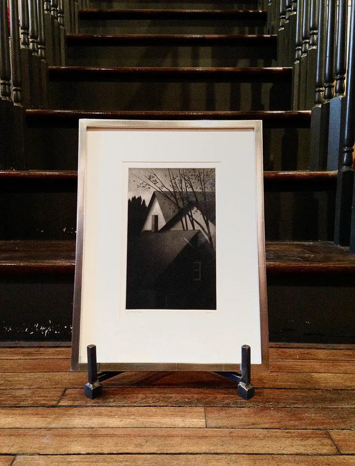 Etching framed in white gold with walnut sides.