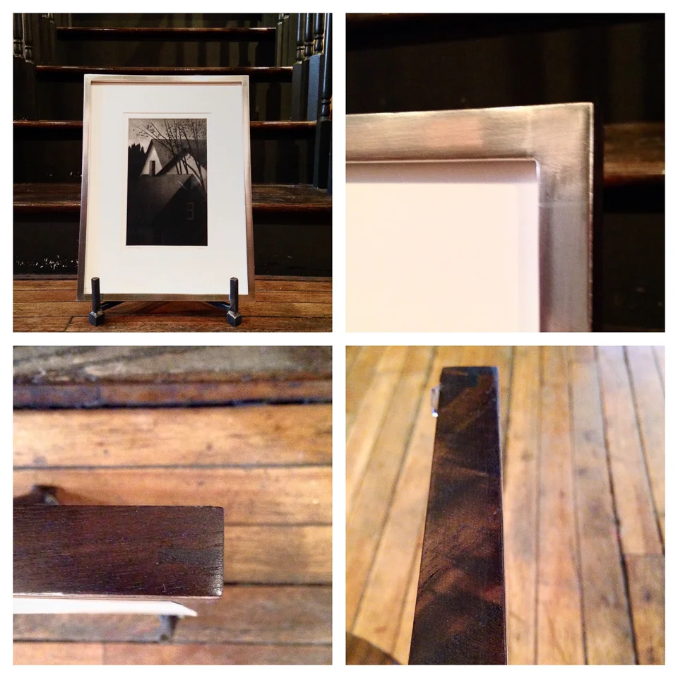 Detail of etching framed in white gold with walnut sides.