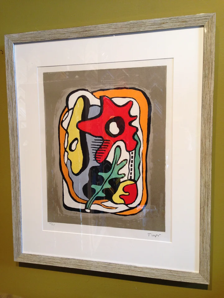 Vintage print reframed in glossy woodtone.