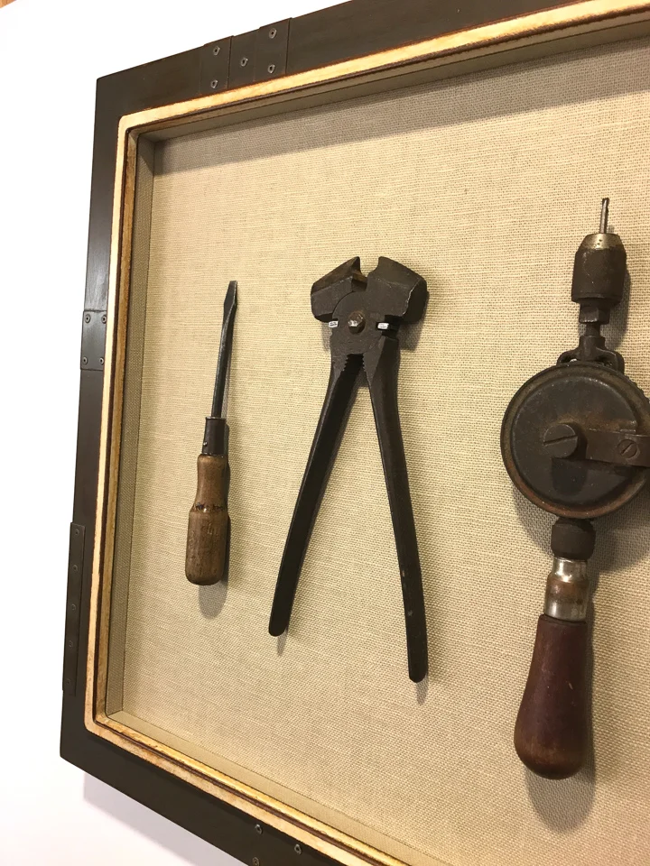 Family tools framed as artwork in riveted steel frame.