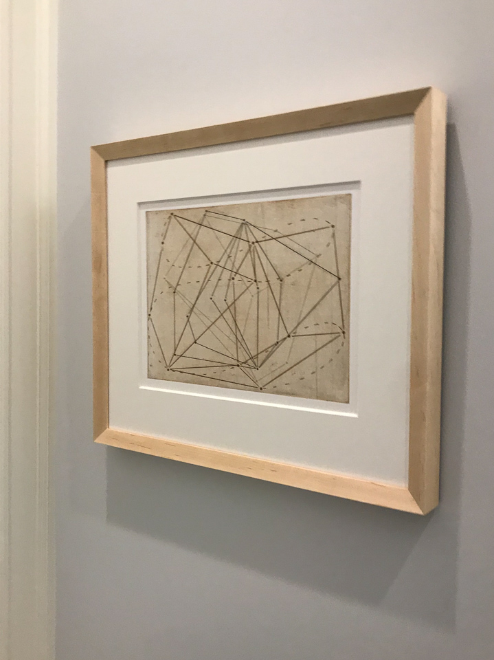 Beautiful geometric print framed in angled maple.