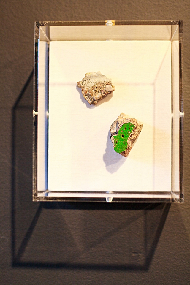 Pieces of the Berlin Wall framed in an acrylic box.
