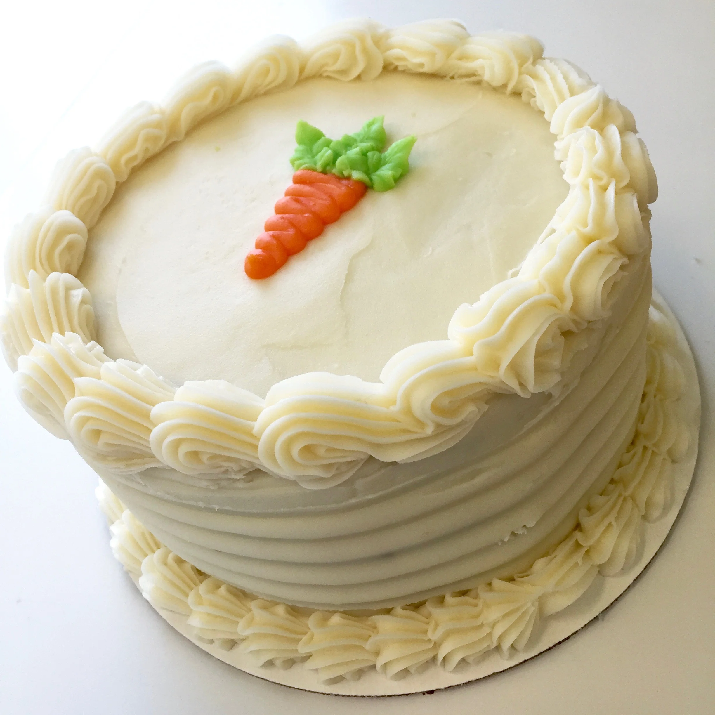 Carrot Cake Three layers filled and finished with a soft cream cheese frosting.