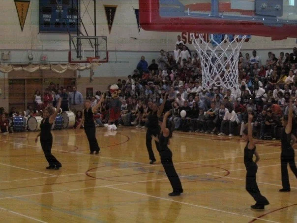Holly Logan (pictured furthest away from the camera) on her high school dance team.