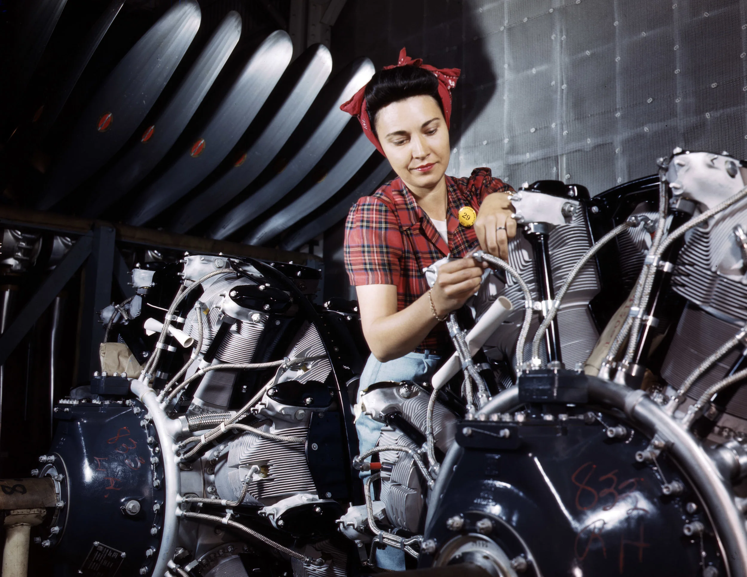 Working on an airplane motor at North American Aviation, Inc., plant in California. Photographer: Alfred T. Palmer