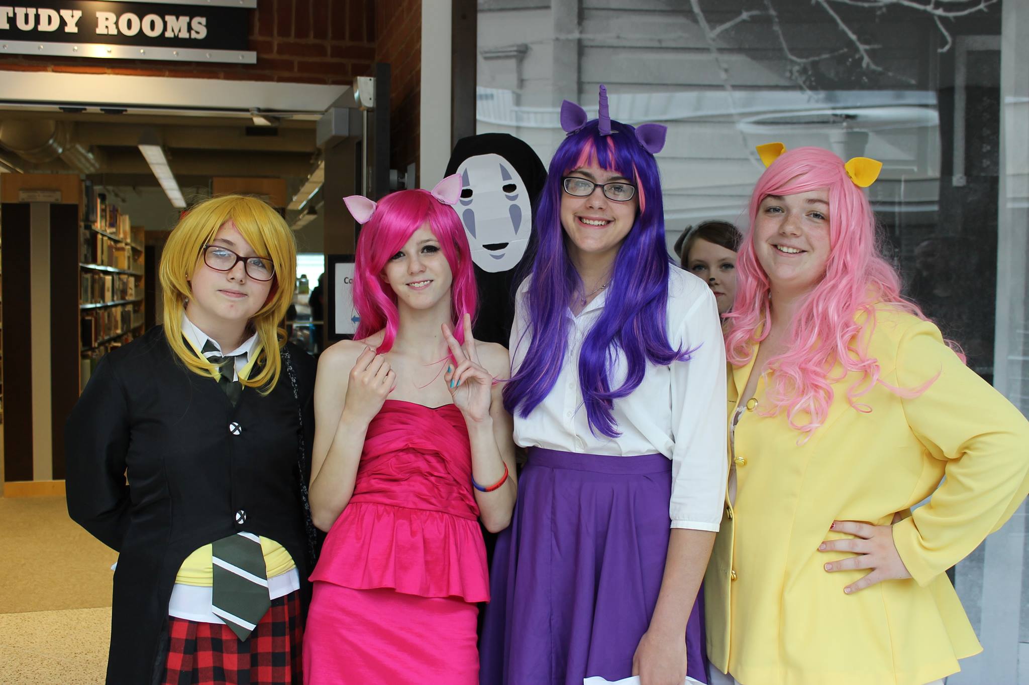 Anime loving girls (and No Face! from Spirited Away ) pose for a picture. 